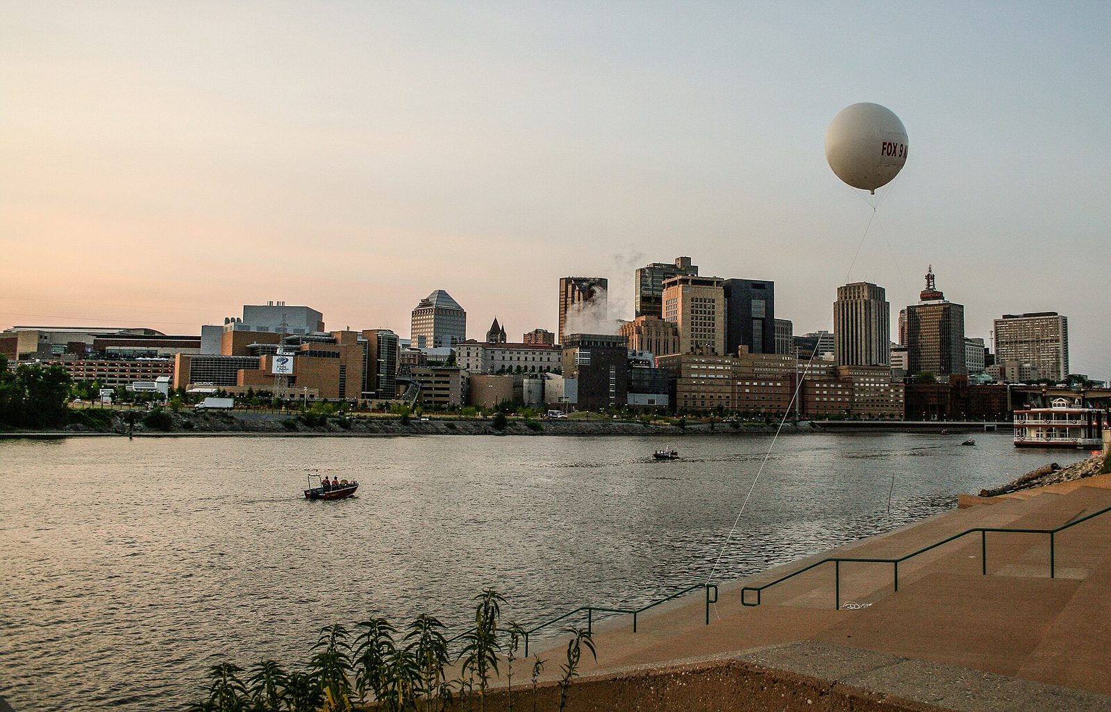 The downtown Saint Paul skyline across the Mississippi River at sunset.